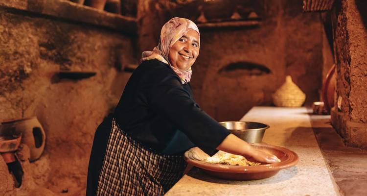 Mujer preparando comida en un entorno tradicional marroquí.