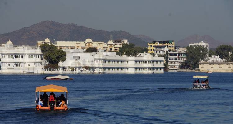 A view of a lake with boats and buildings.