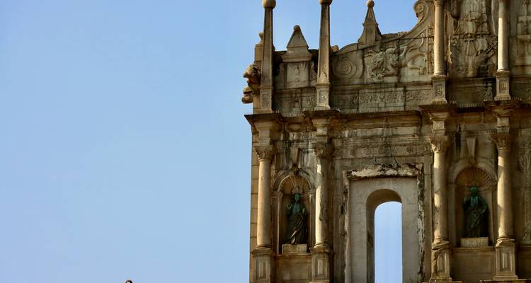 Close-up of the Ruins of St. Paul's against a blue sky.