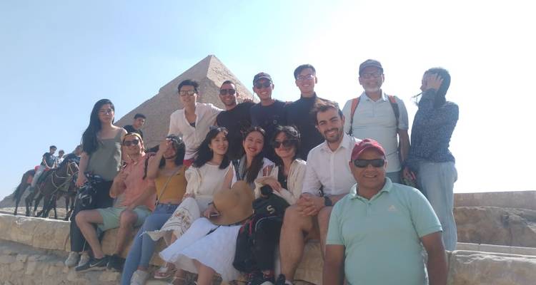 Large group posing in front of the pyramids.