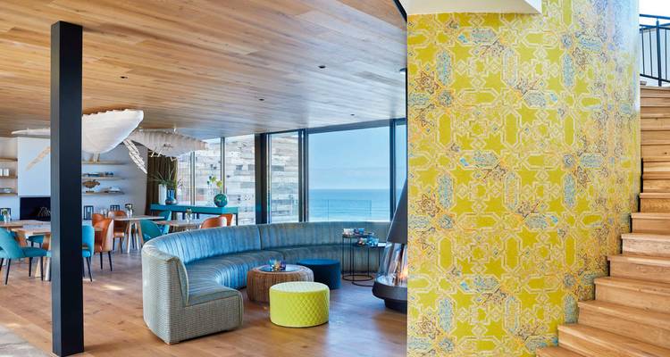 Interior of a modern lounge with sea view and colorful decor.