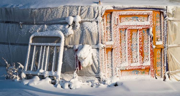 A detailed view of a yurt door and frosty surroundings.