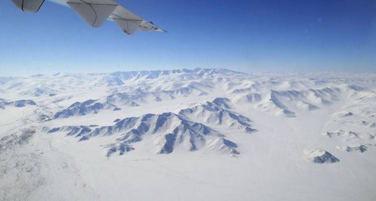 Aerial view of snow-covered mountain range.