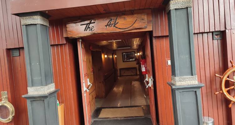 Eingang eines rustikalen Gebäudes namens 'Die Arche'.