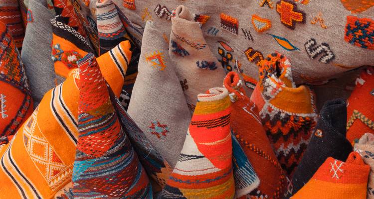 Colorful textiles and cushions on display.
