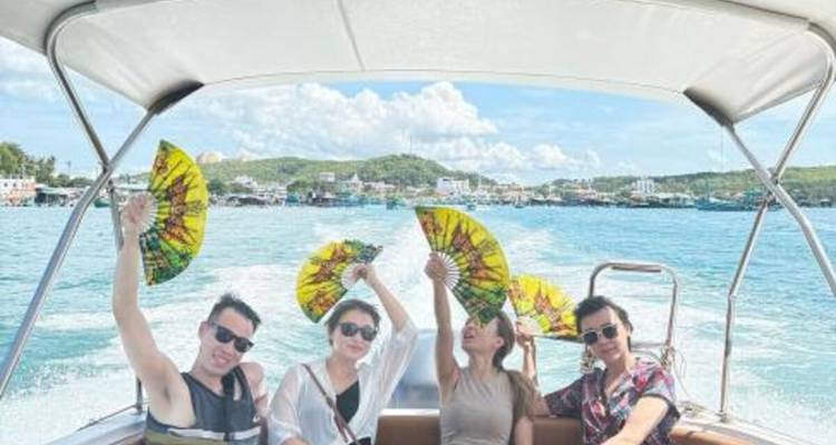 Quatre personnes sur un bateau profitant de la vue sur l'océan avec des éventails traditionnels.