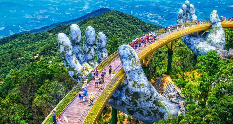 Golden bridge held by giant stone hands with tourists on a mountaintop