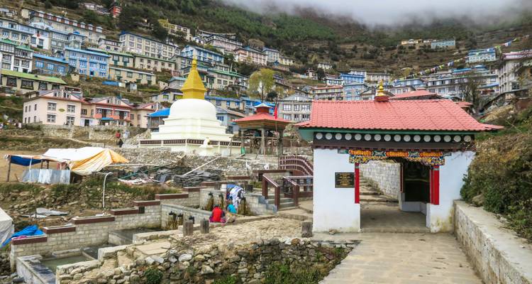 A bustling village with colorful buildings in a hilly area.