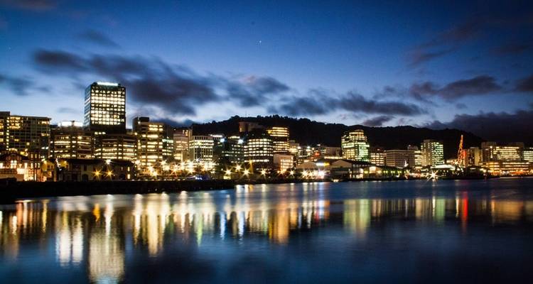 City skyline reflected in the water at night.