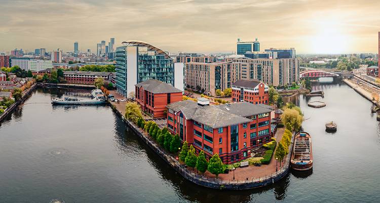 Cityscape with modern buildings and a river.