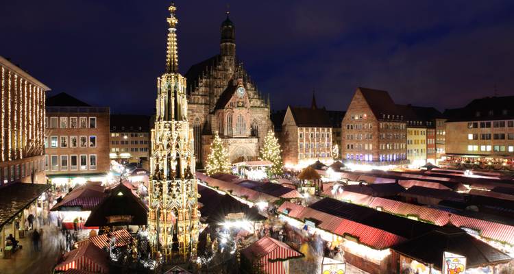 Night view of a Christmas market with historic church