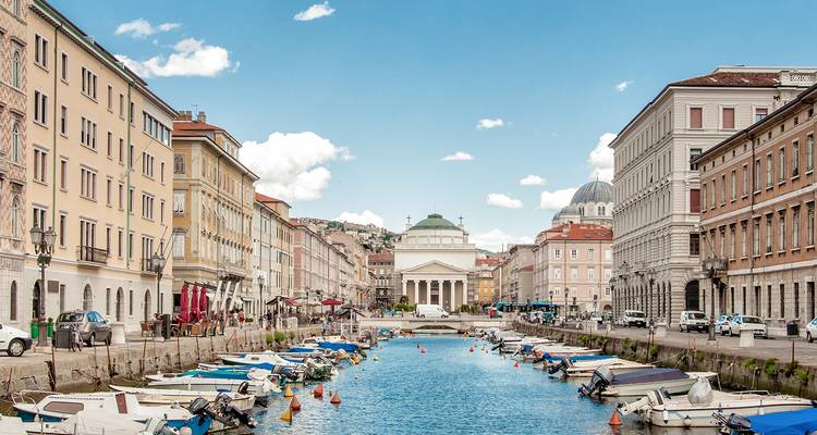 Canal with boats and historical architecture in Trieste.