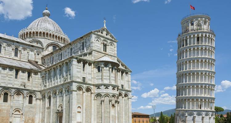 Iconische Scheve Toren van Pisa en de Kathedraal van Pisa onder een helderblauwe zomerhemel.