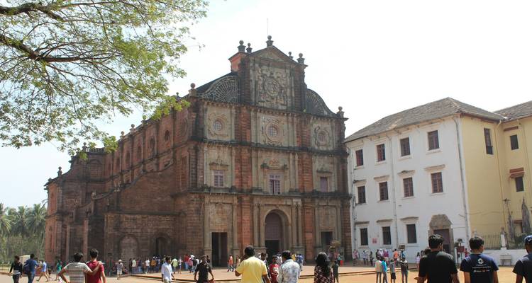 A historic church structure with visitors in front.