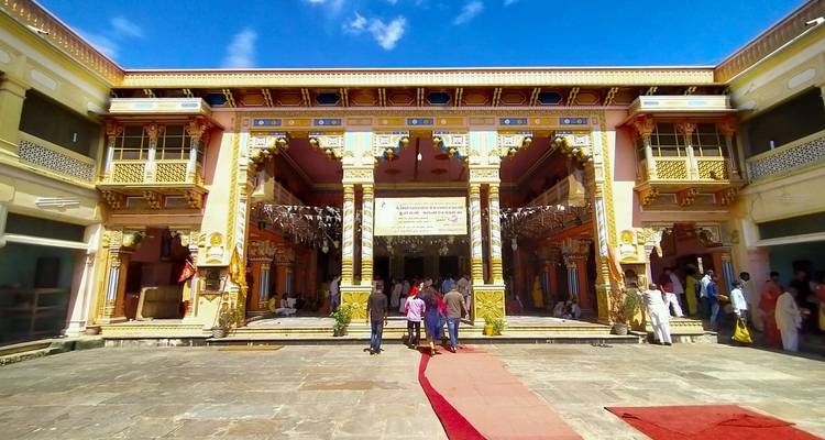 A temple courtyard with detailed architecture and visitors.