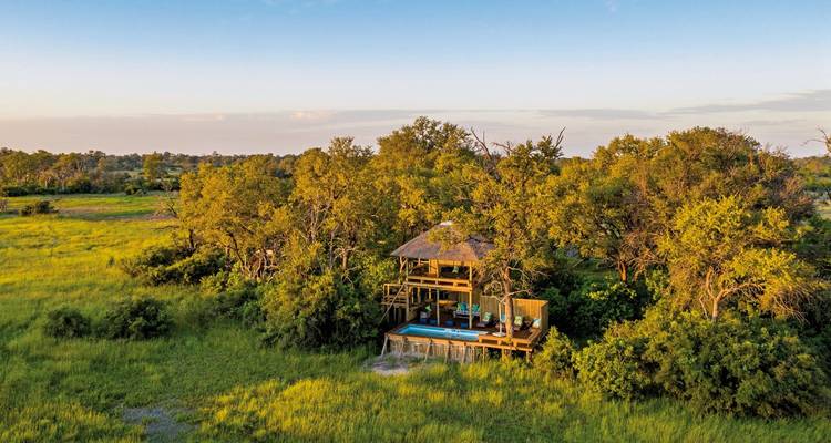 Aerial view of a lodge nestled in lush green environment