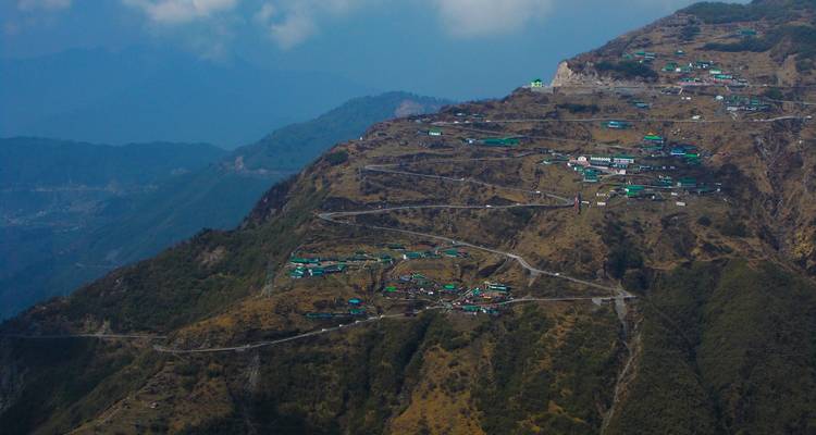 Maisons à flanc de colline avec des routes sinueuses qui montent.