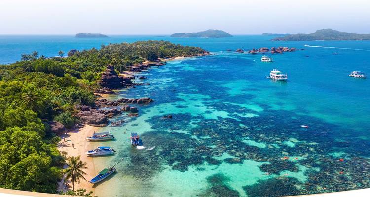 Idyllic coastal scene with clear waters and small islands.