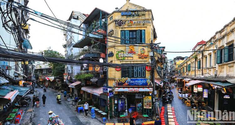 Lively urban street with colorful buildings and outdoor seating.