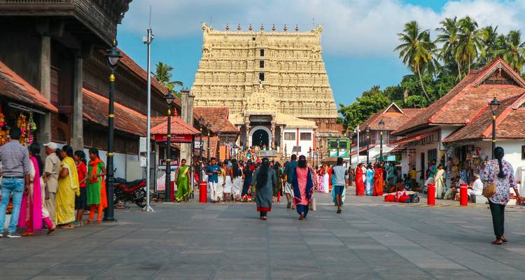Crowded street with people in front of a historic temple.