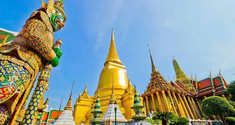 Grand palace with a giant golden stupa and detailed architecture.