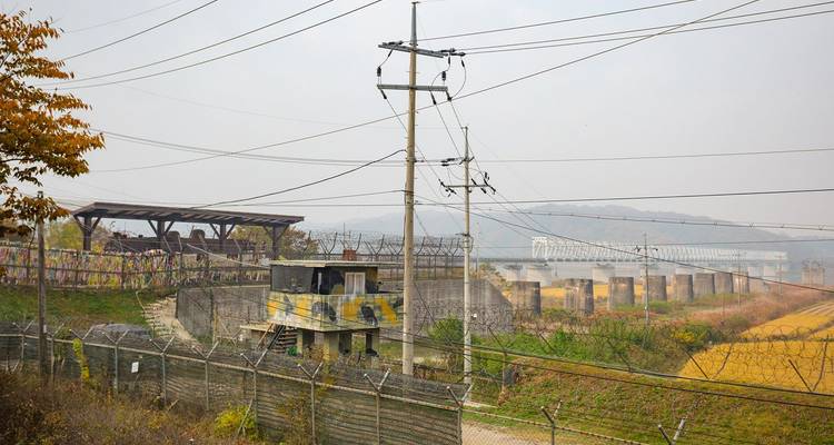 Barbed wire fences, guard tower and railway tracks at a hazy section of the Korean DMZ