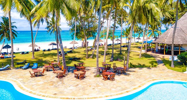 Beach resort with palm trees and ocean view.
