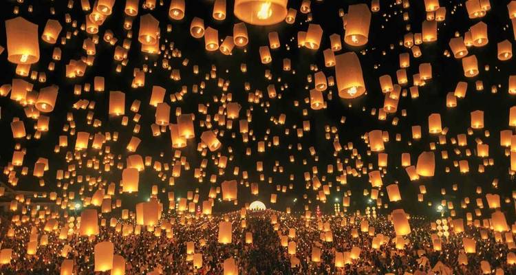 Thousands of glowing lanterns float into the night sky during the Yi Peng festival in Thailand