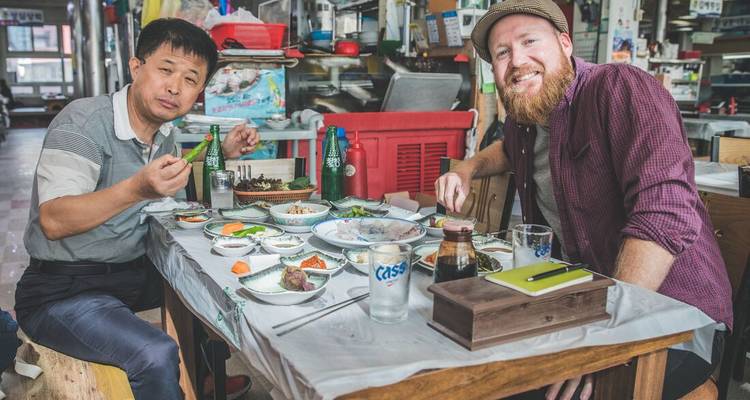 Two men enjoying a traditional meal together.