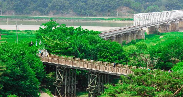 Scenic river with a long wooden bridge.
