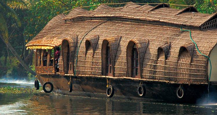 Traditional wooden houseboat on a serene waterway.