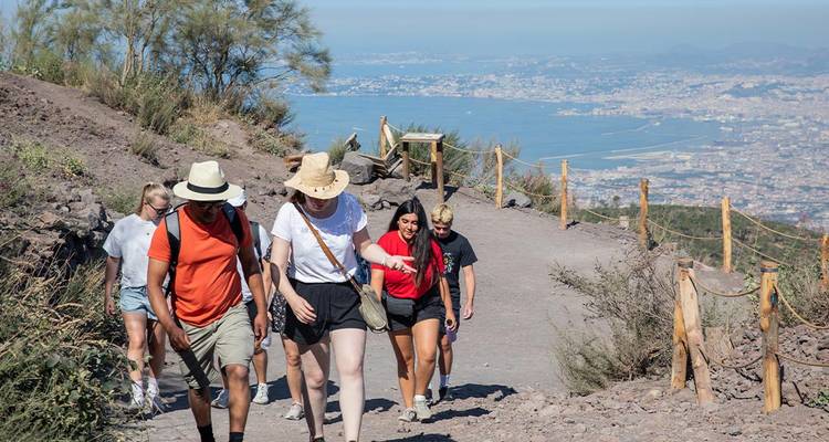 Group hiking on a hill with a town in the distance.