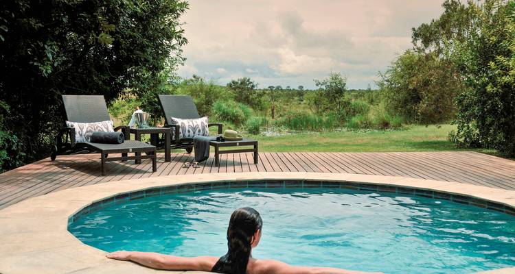 Private circular pool with a view of nature.