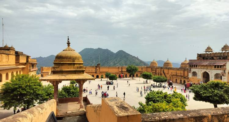 Amber Fort in Jaipur with people walking around a courtyard.
