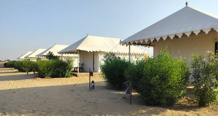 Row of luxury tents in a desert camp.