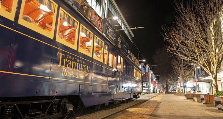 Christchurch Tramway Restaurant tram on a city street at night.
