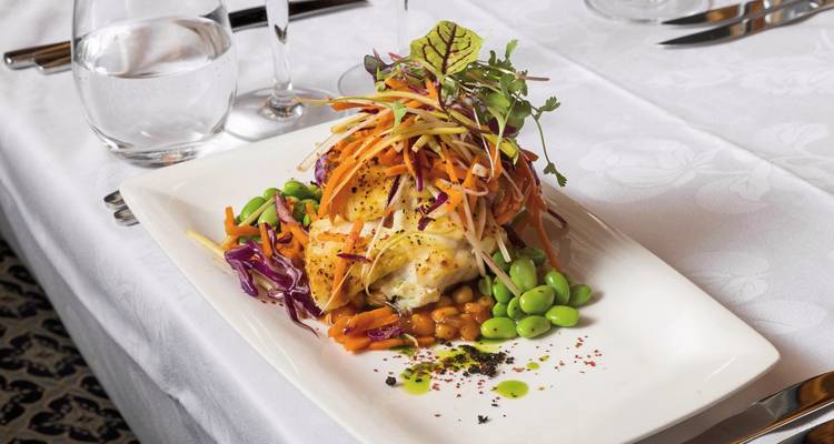 Gourmet plated dish with vegetables and fish.