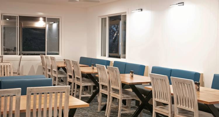 Minimalist dining area with tables and chairs.