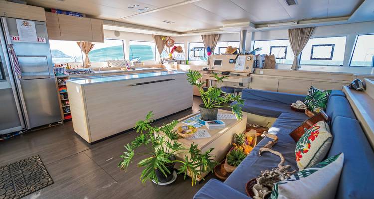 Interior of a boat with plants and seating area.