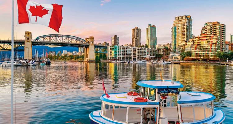 A view of Vancouver's downtown skyline and waterfront at sunset.