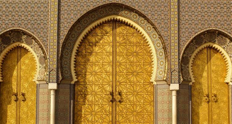 Close-up of ornate golden door with intricate design.