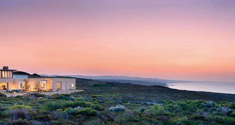 Zeitgenössisches Haus mit Panoramablick auf das Meer bei Sonnenuntergang.