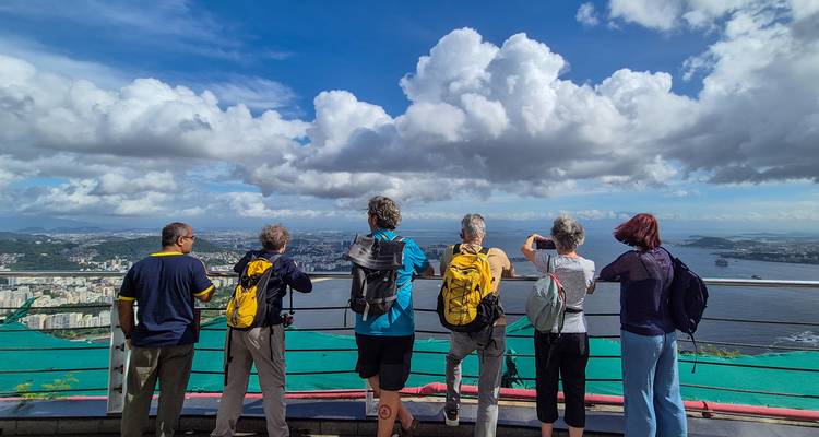 Travellers photograph Rio de Janeiro’s skyline and bay from a high viewing deck.