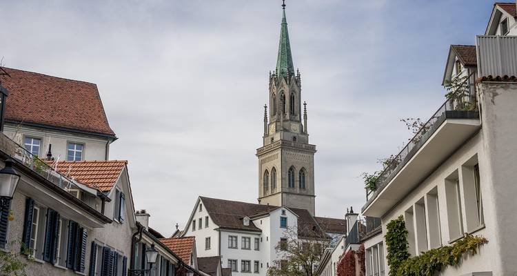 Charming street with historic buildings and a church tower.