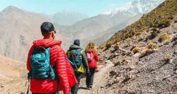 Hikers walking along a mountainous trail.