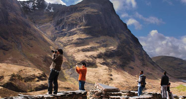 Tourists taking photos of scenic mountains