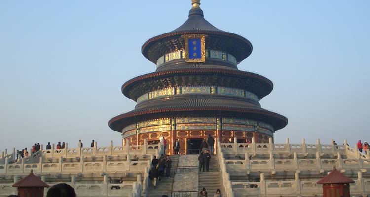 Temple of Heaven with tourists climbing the steps.