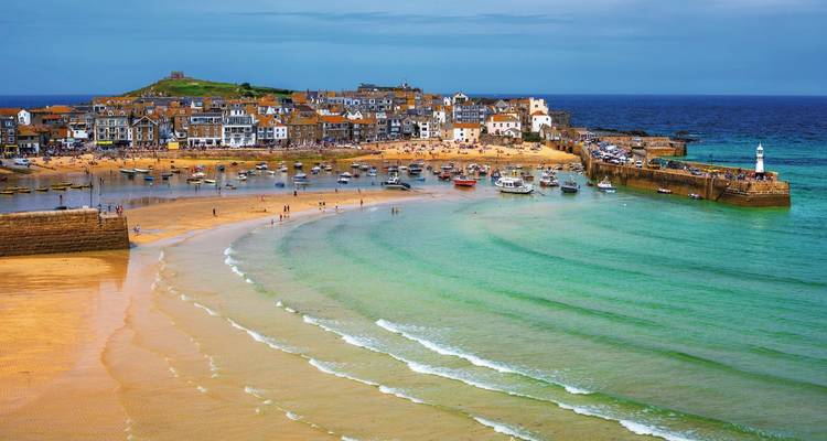 Harbour with boats and sandy beach in St Ives.