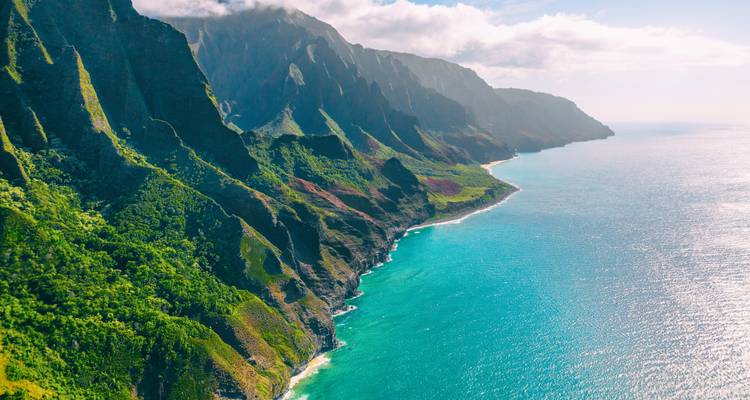 Aerial view of dramatic coastline with steep cliffs.