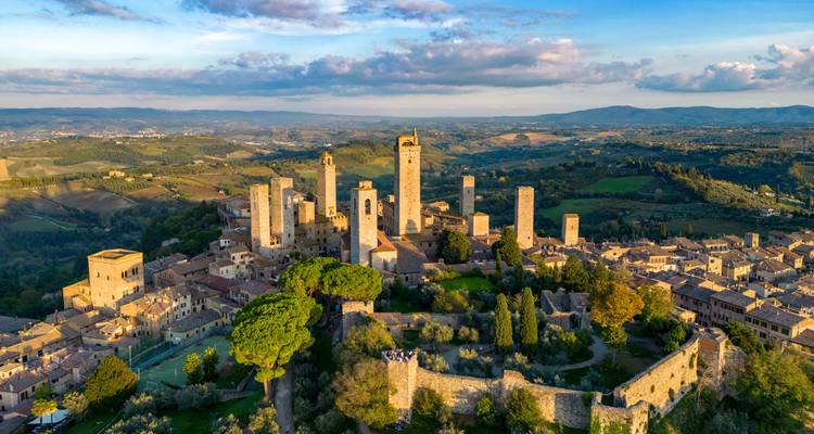 Vue aérienne de San Gimignano avec ses tours médiévales au coucher du soleil.